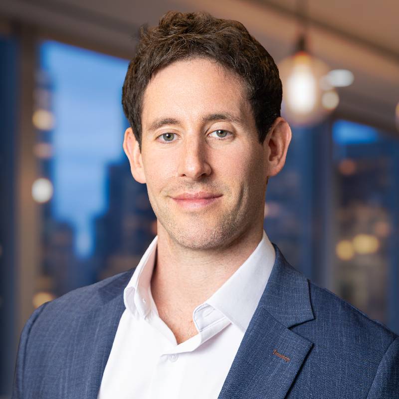 Smiling professional man in suit, office background