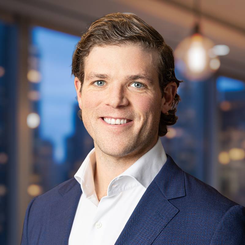 Smiling businessman in navy suit in office