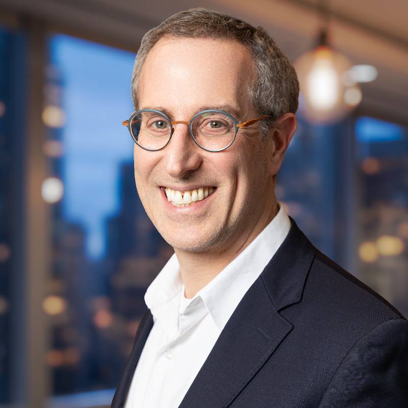 Smiling man in glasses and blazer